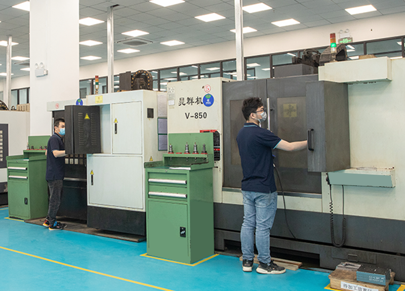 DELIXI technician using state-of-the-art CNC Machining center for complex precision parts production